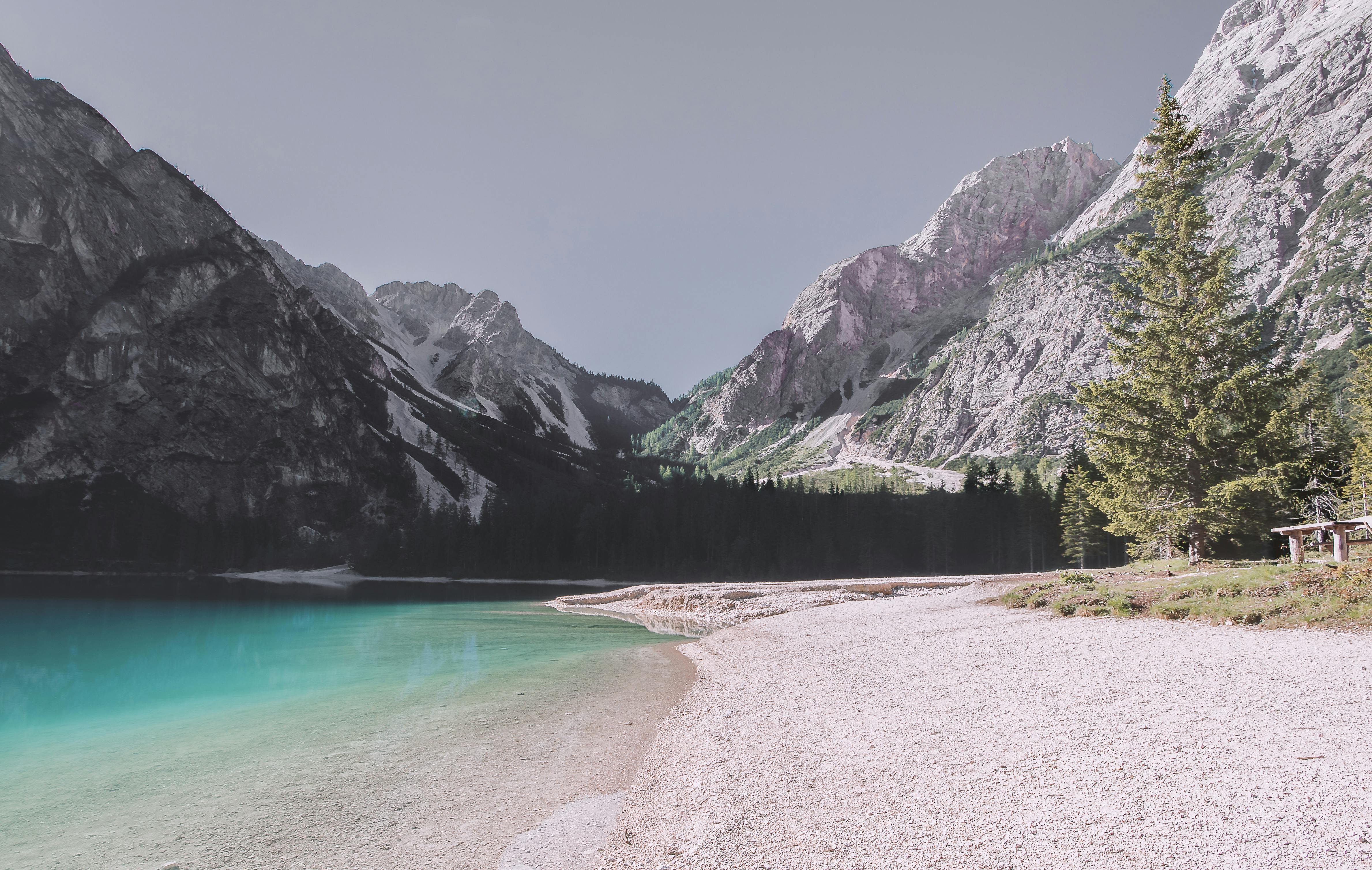 A serene alpine lake surrounded by majestic mountains and forest.