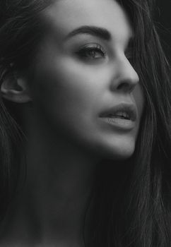 Elegant monochrome side profile of a woman with long hair, reflecting natural beauty and grace.