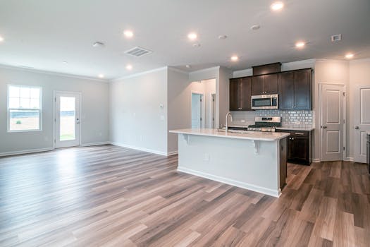 Spacious open-concept kitchen and living area with contemporary design and wooden flooring