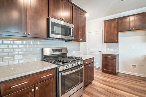 Free Sleek kitchen interior featuring stainless steel appliances and wooden cabinetry. Stock Photo