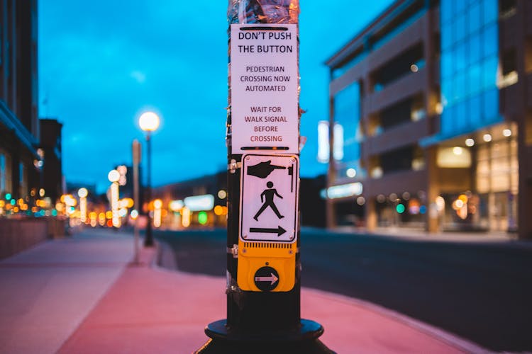 Pedestrian Call Button On Crosswalk In Contemporary City In Evening