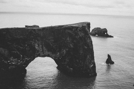 Black and white of natural arch of Dyrholaey cape in Iceland