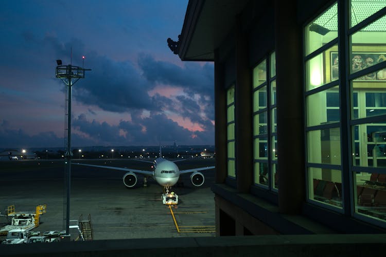 Aircraft Parking Near Airport Terminal At Night