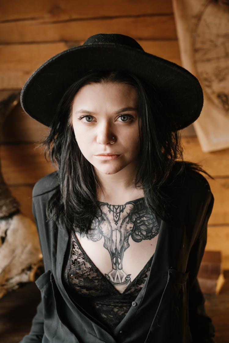 Young Informal Woman In Hat With Big Tattoo On Chest