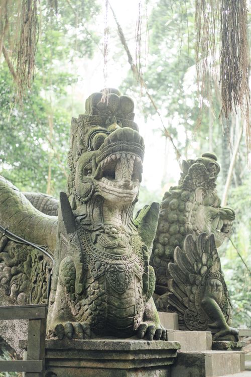 Free Stone sculpture of Asian mythological guardian creature located in religious park in sunny jungle Stock Photo