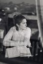 Serious young lady with thick book looking away