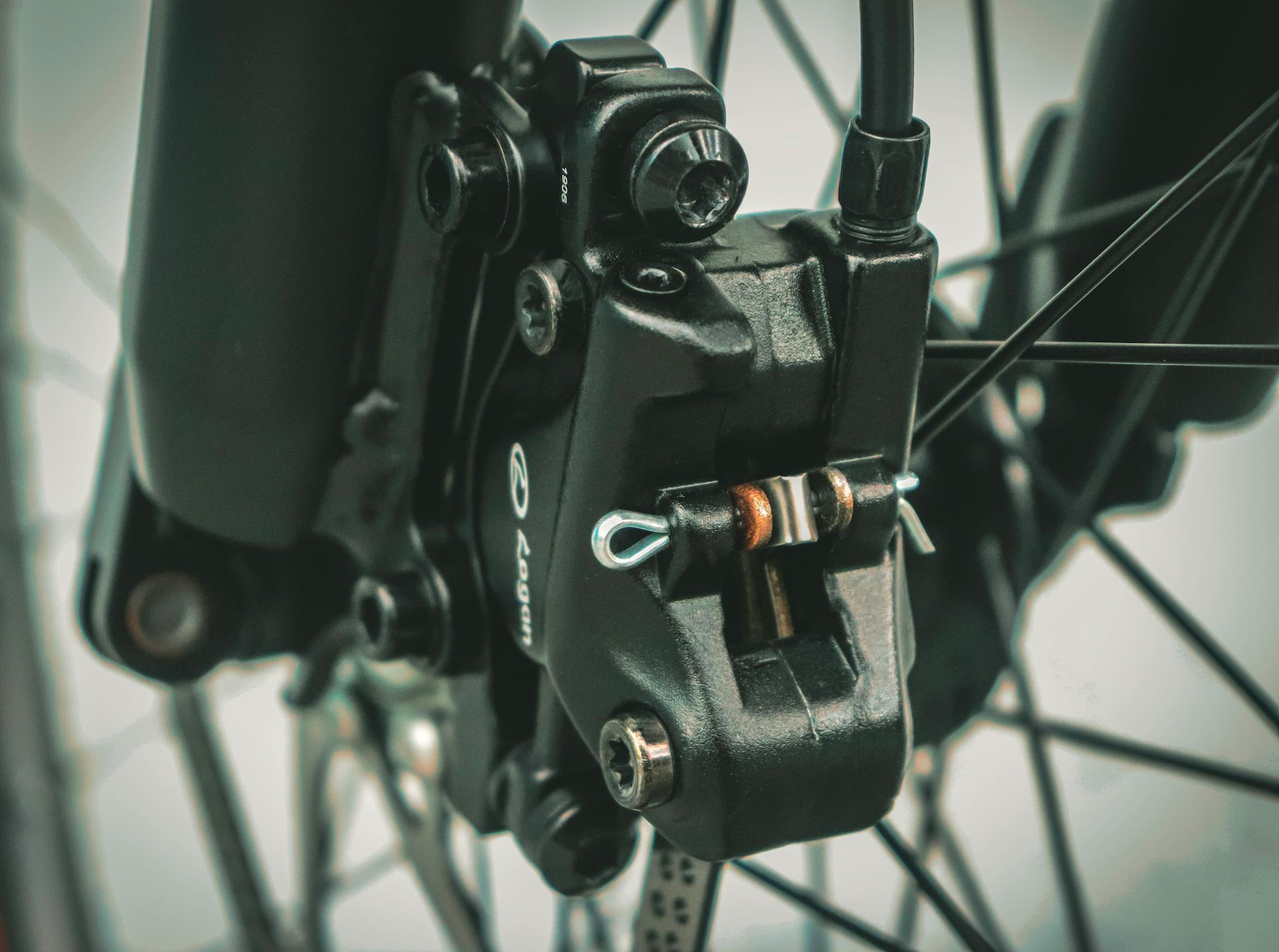 Detailed macro of bicycle brake showcasing mechanical components and engineering.