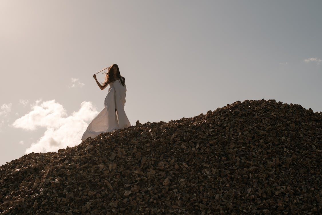 Woman in White Dress Standing on a Hill 