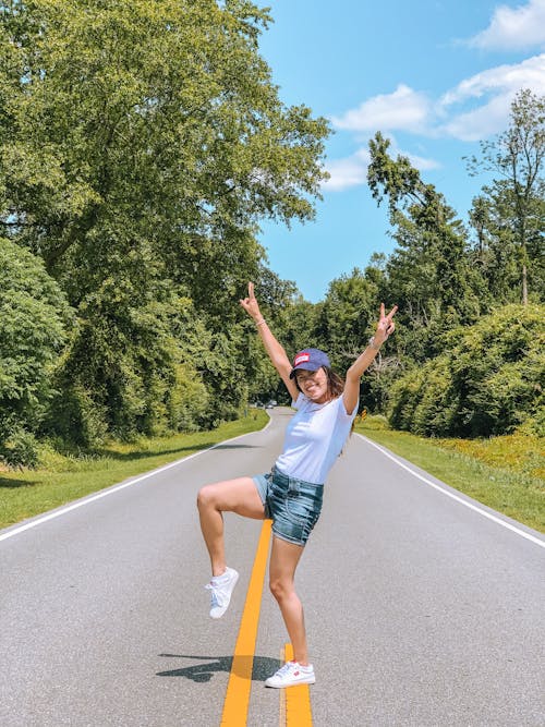 Happy young woman on road in countryside