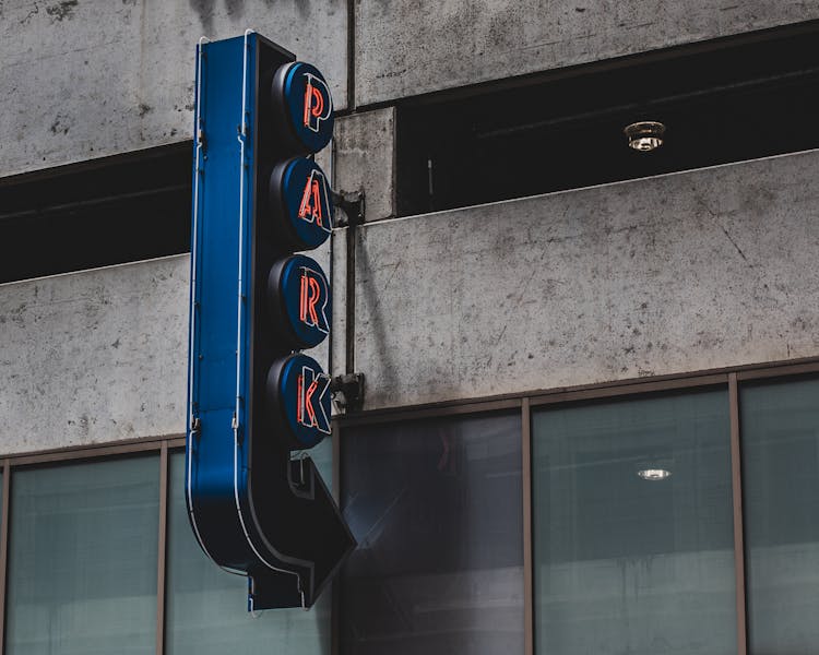 
A Parking Lot Signage Attached On The Wall