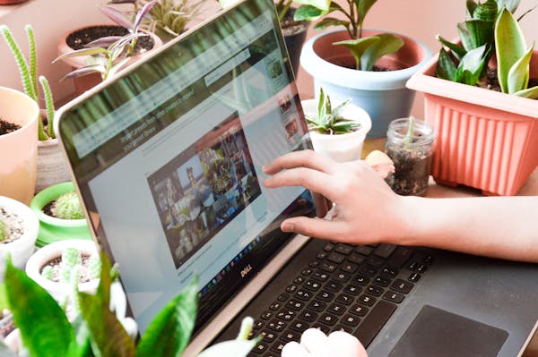 a person touching a laptop screen