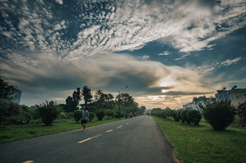 Free People walking along asphalt road in countryside Stock Photo