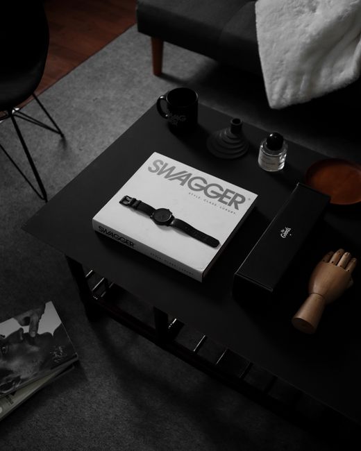 Stylish setup with a wristwatch on a sleek coffee table in a modern living room setting.