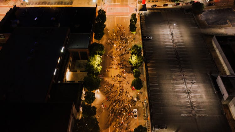 Crowd Of People Walking In City At Night