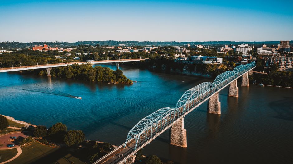 Breathtaking Ultimate Scenic Experience Review: The Best Tennessee Helicopter Tour Over Chattanooga Review 2026 - Drone view of modern bridge crossing calm river and connecting shores of town