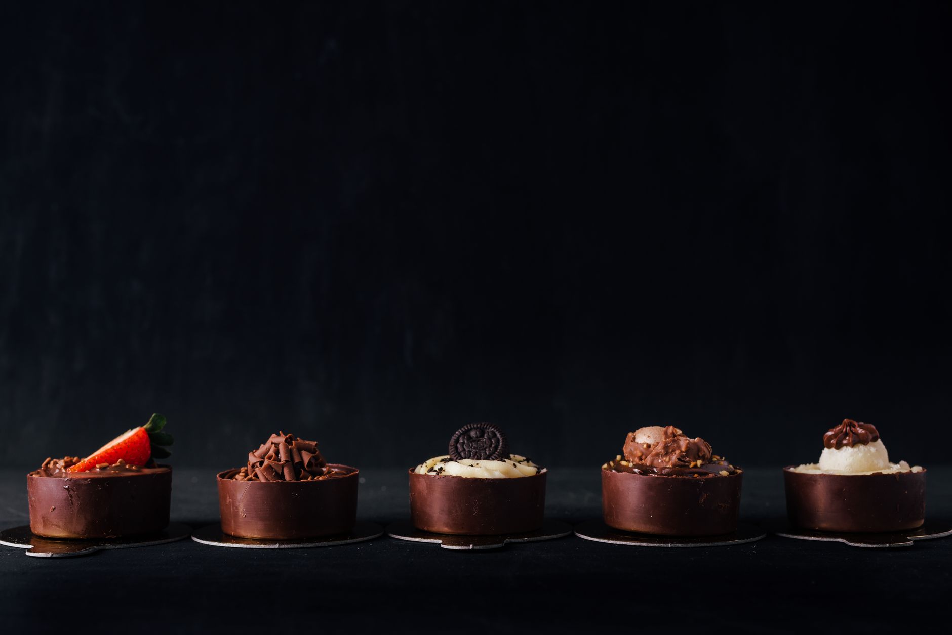 Dark chocolate squares paired with blue cheese slices on wooden platter