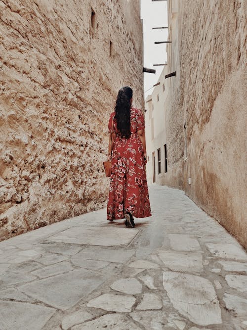 Woman walking on narrow old street