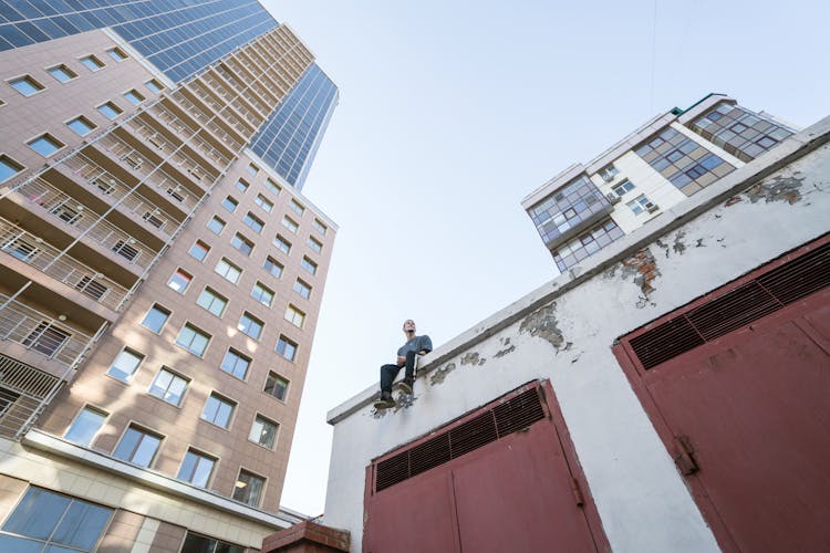 Free Runner Relaxing On Edge Of Garage Roof