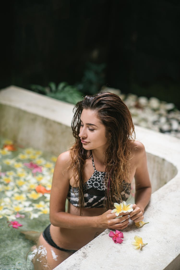 Young Lady In Bikini Relaxing In Pool At Spa Resort