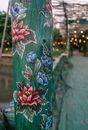 Ornamented wooden pole of outdoor cafe
