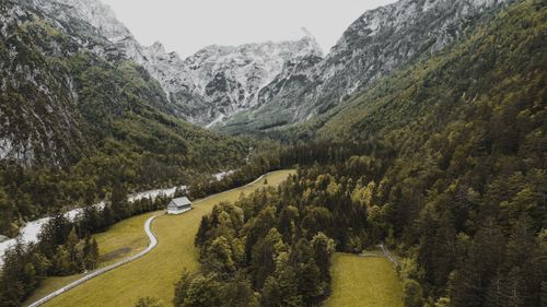 Free High angle of green valley covered with dense forest and surrounded with high mountains Stock Photo
