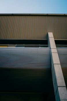 Low angle view of a contemporary building showcasing minimalist design and a corrugated metal facade.