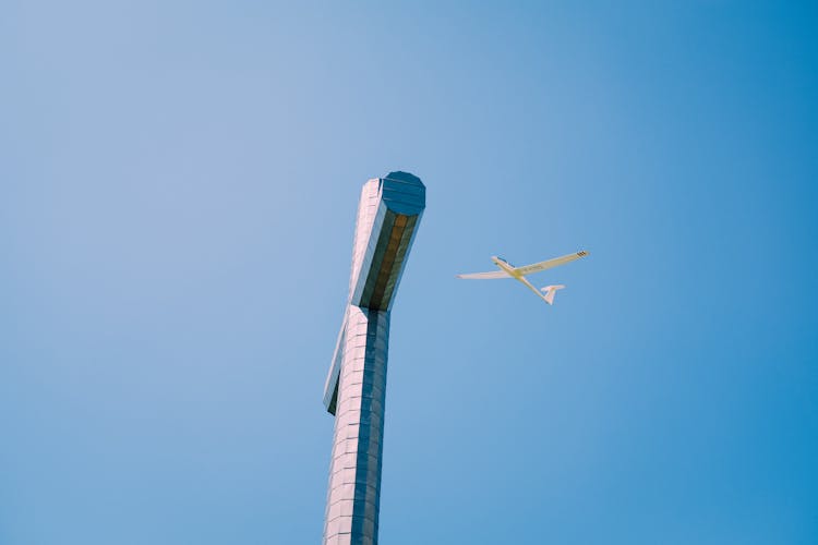 Plane Flying Over Old Religious Monument