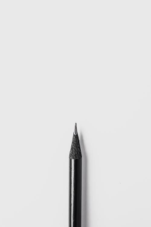 Black Pencil on White Surface