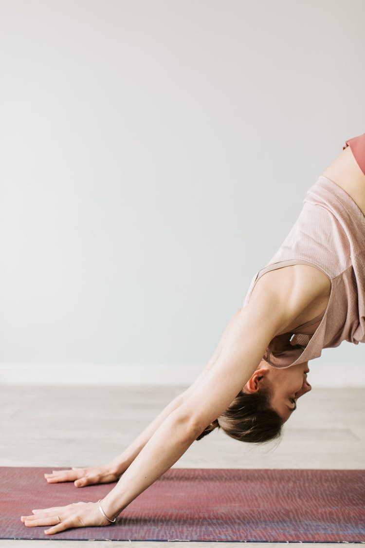 A Woman In A Downward Facing Dog Position