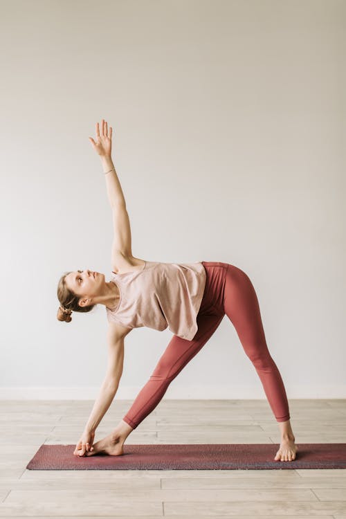 A Woman in Tank Top and Legging Side Bending