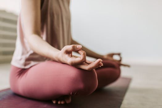 Close-up of a woman meditating indoors, practicing yoga for wellness and relaxation.