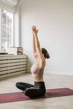 Woman performing yoga meditation indoors, promoting wellness and relaxation.