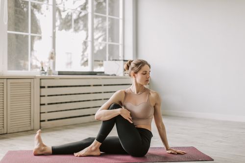 Free A serene moment of a woman doing yoga indoors, focusing on relaxation and flexibility. Stock Photo