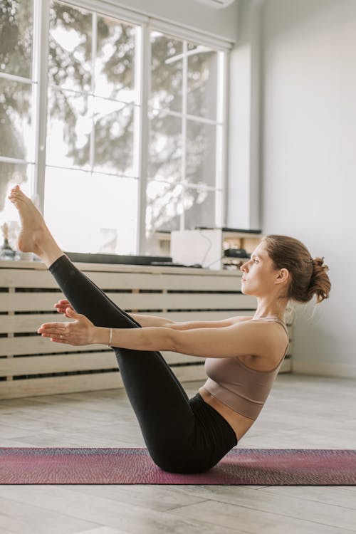 Woman in Sports Bra and Black Leggings Doing Yoga