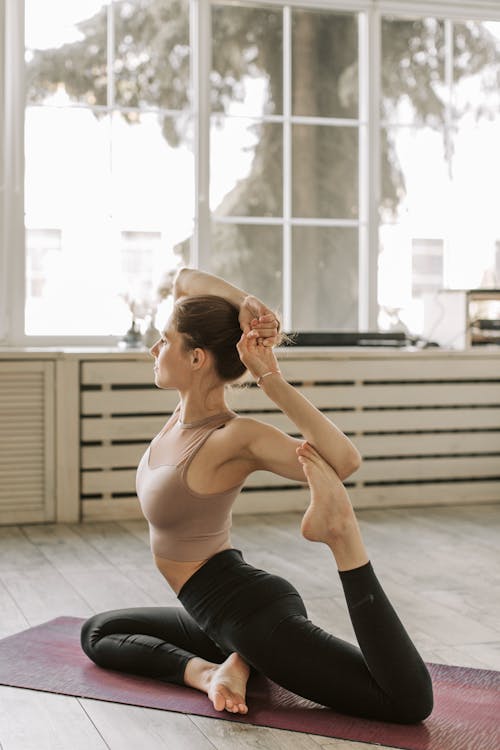 Woman in Activewear Doing Yoga at Home