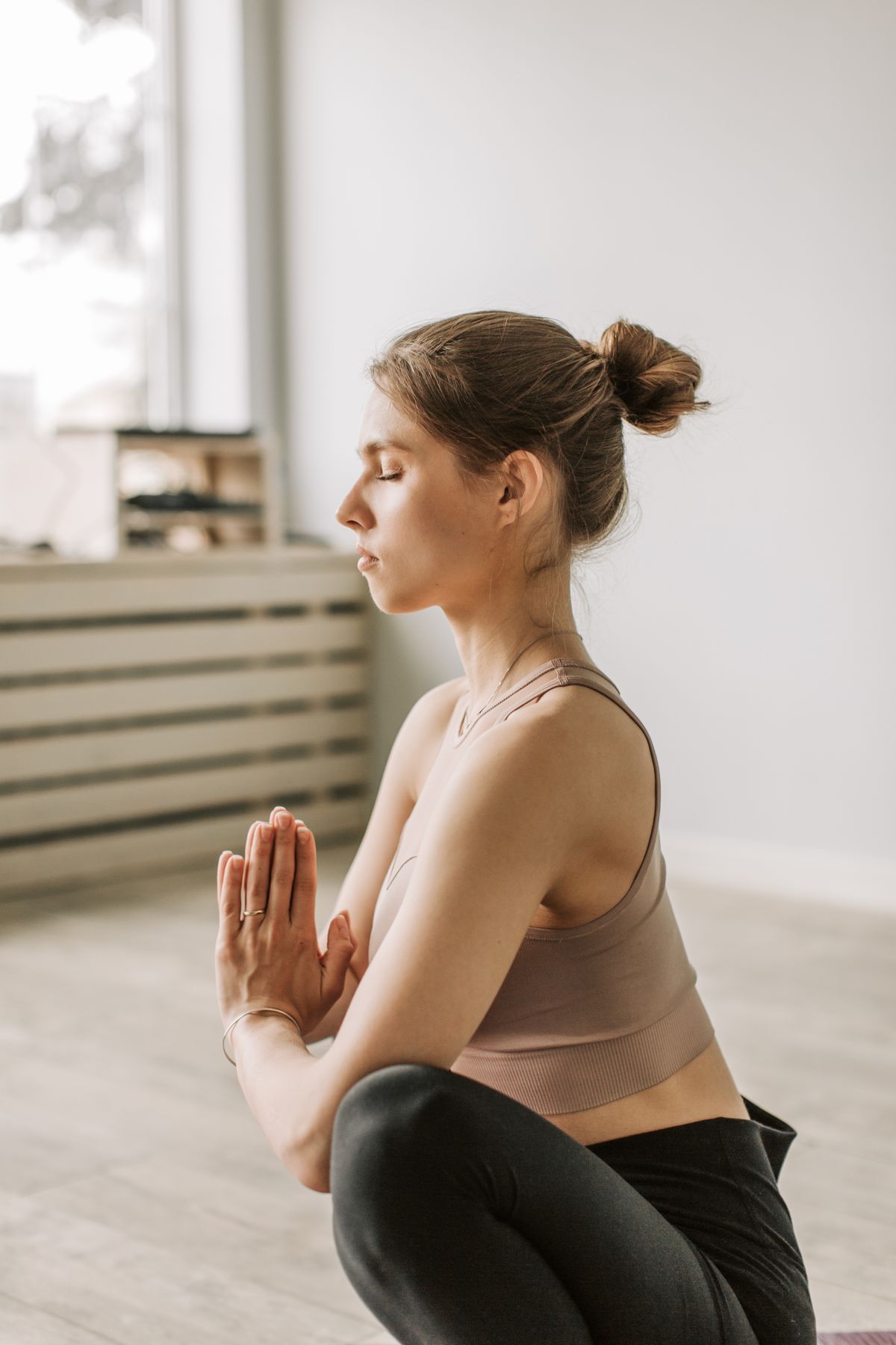Calm woman with closed eyes practicing quiet focus indoors