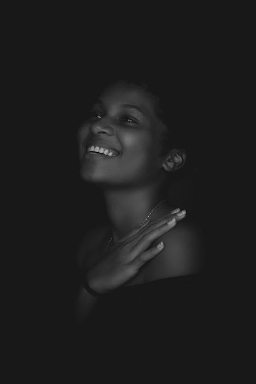 Grayscale Photo of Smiling Woman