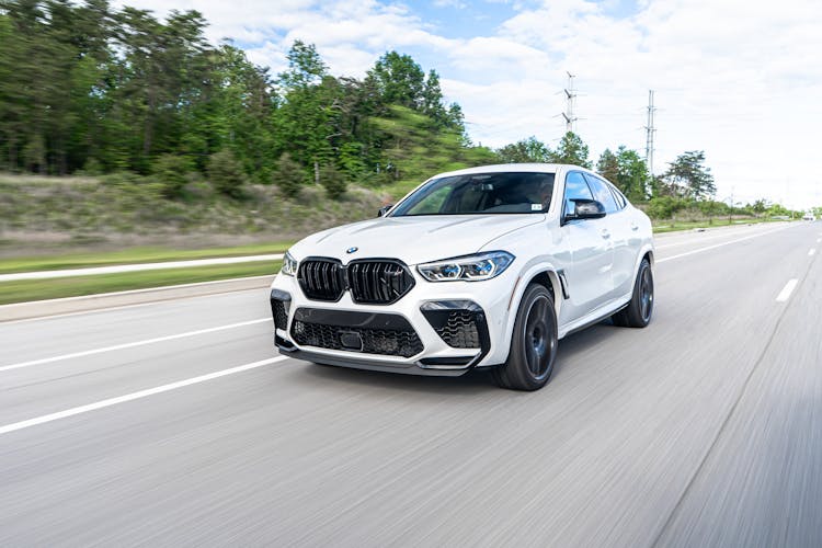 Luxury Car Driving Through Paved Road