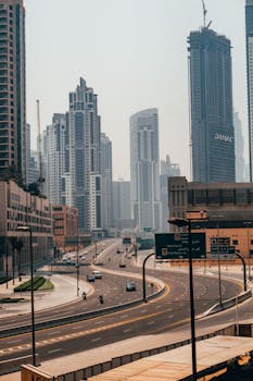 A vibrant day view of Dubai's towering skyscrapers and urban roads, showcasing modern architecture.
