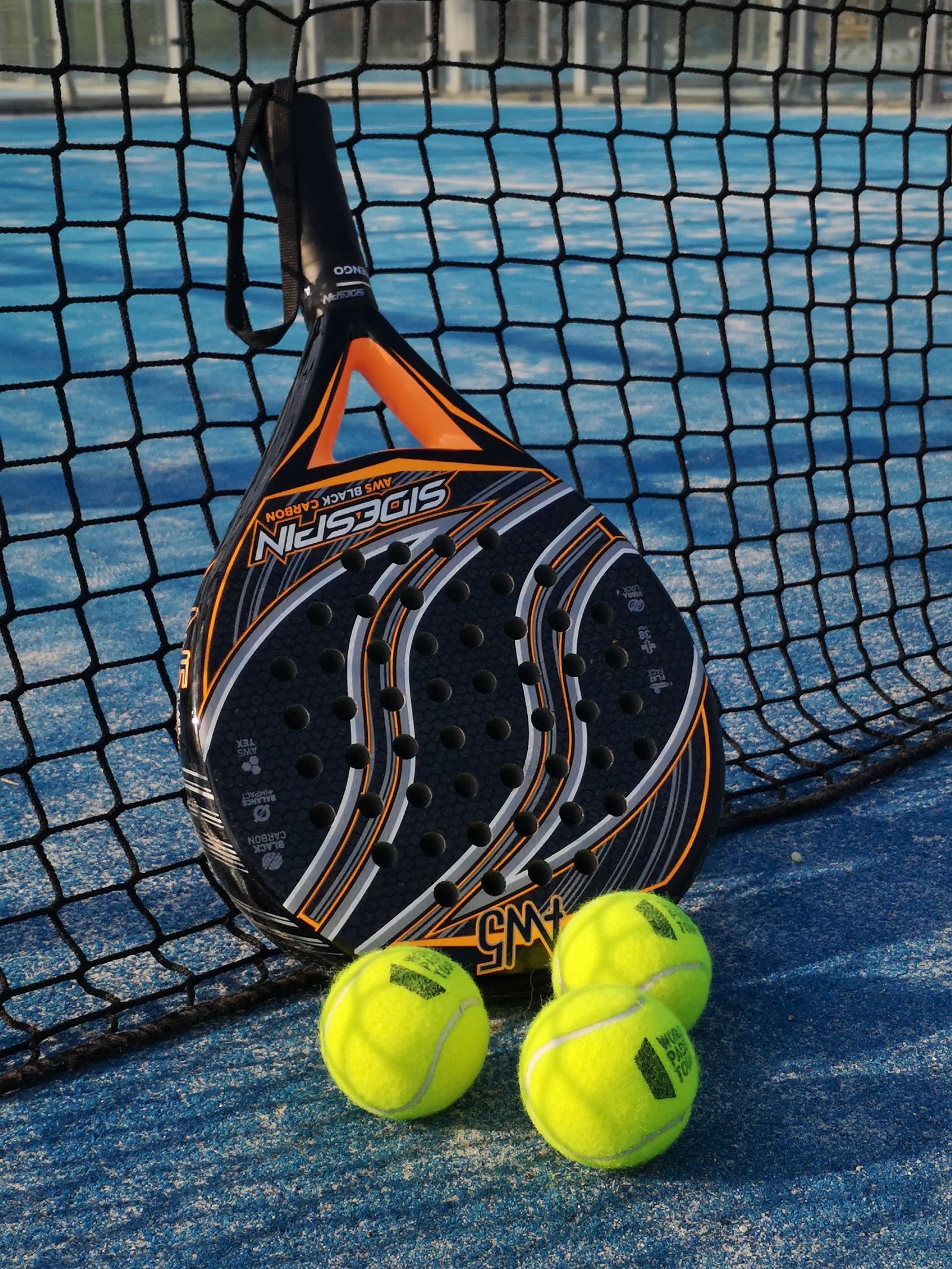 Padel rackets and balls on court