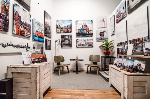 A chic art gallery showcasing urban landscape paintings with modern interior design.