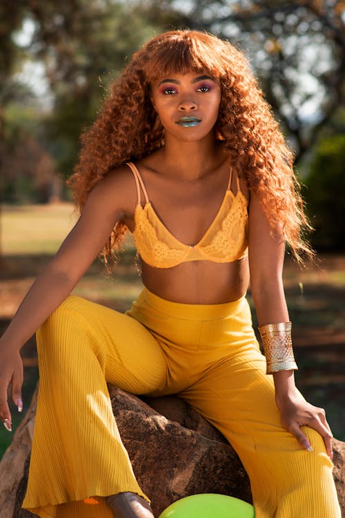 A Woman in Yellow Bra Posing at the Camera