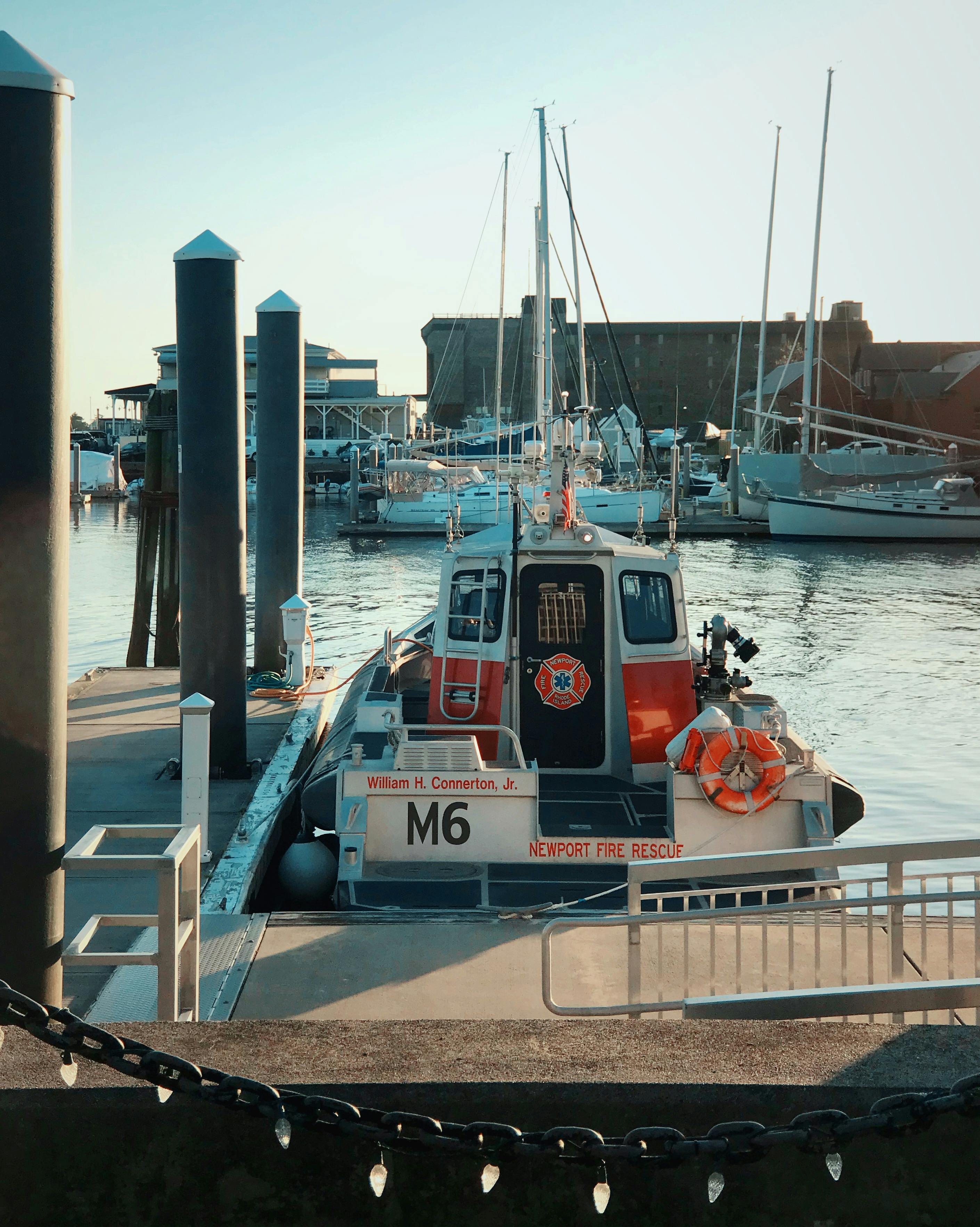Free A fire rescue boat docked at Newport Harbor in Rhode Island during sunset. Stock Photo