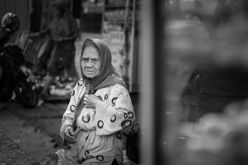 Elderly Woman Wearing a Headscarf on a Street 