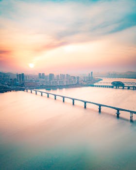 Breathtaking aerial view of Seoul's skyline and bridge during a serene sunrise, showcasing the city's vibrant architecture.