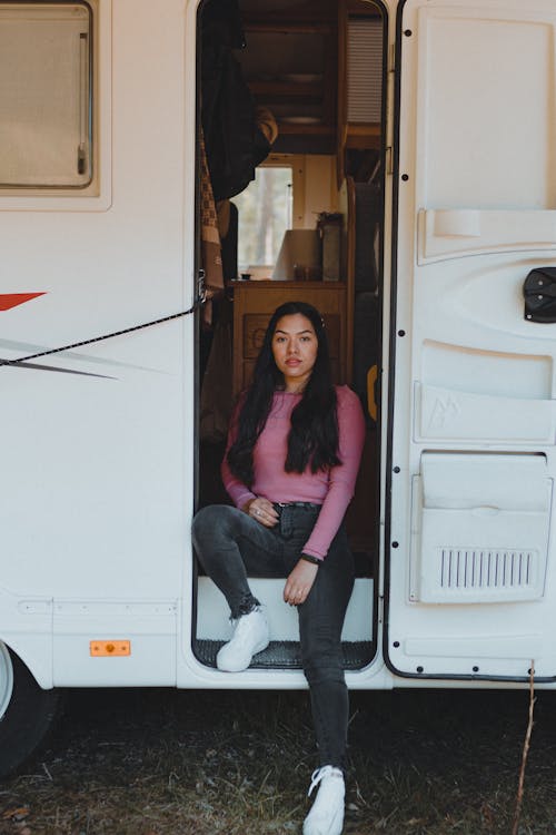 Woman Sitting on Campervan Stairs