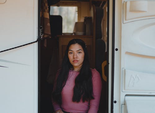 Woman in Front of her Campervan Door