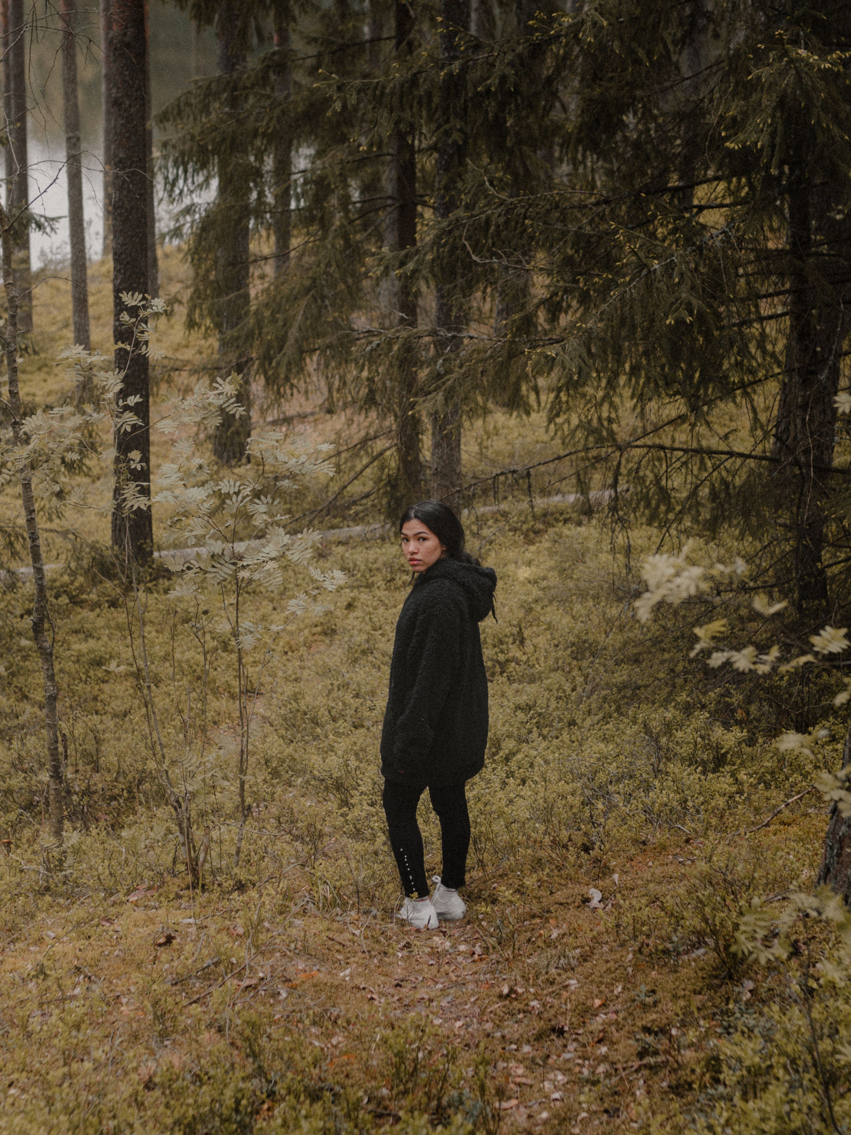 Woman Standing on a Forest and Looking Back · Free Stock Photo