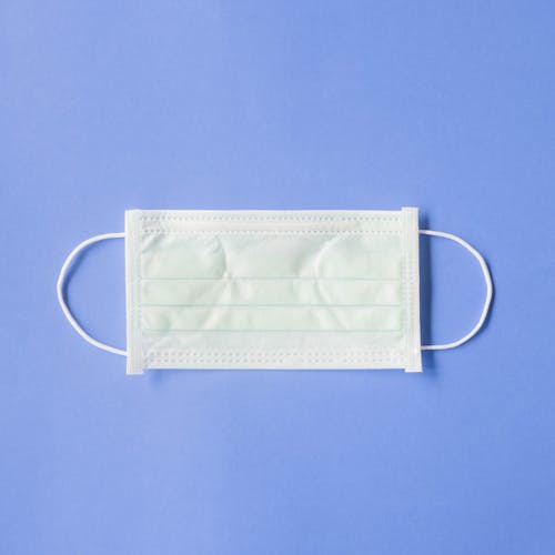 Free Medical mask placed on blue background Stock Photo