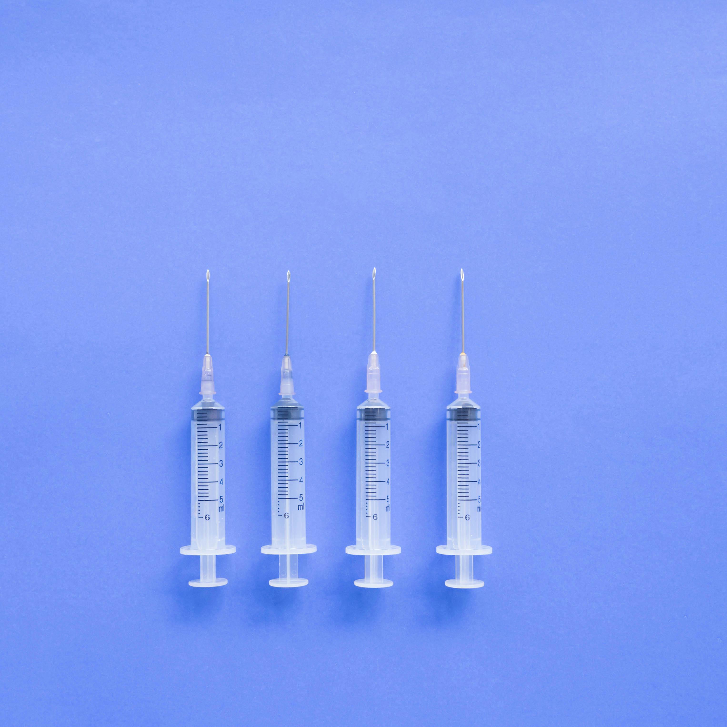 medical syringes placed on blue surface